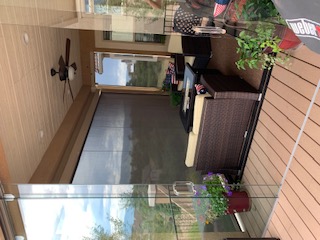 Part of this composite deck becomes a 3-season room with glass panels and doors.